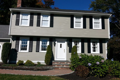 Photo of a large and beige traditional two floor house exterior in Boston.