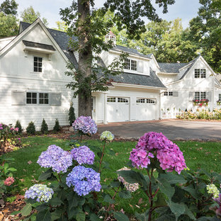 Inspiration for a mid-sized country white two-story wood house exterior remodel in Minneapolis with a shingle roof