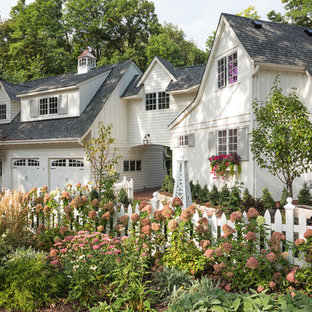 Inspiration for a mid-sized cottage white two-story wood house exterior remodel in Minneapolis with a shingle roof