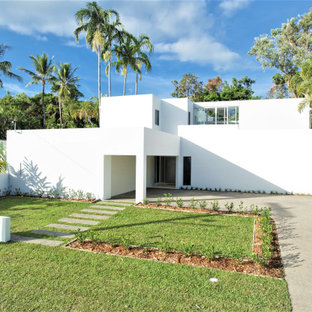 Design ideas for a modern two-storey white house exterior in Cairns with a flat roof.
