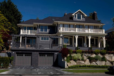 Inspiration for a large timeless gray three-story wood house exterior remodel in Seattle with a hip roof and a shingle roof