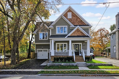 Mid-sized traditional beige two-story wood gable roof idea in Toronto