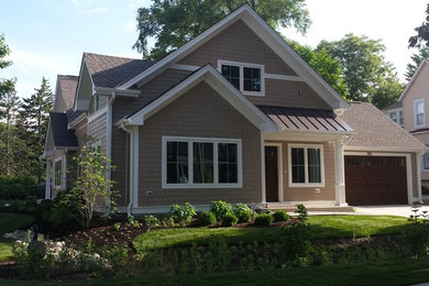 Small arts and crafts beige two-story gable roof photo in Chicago