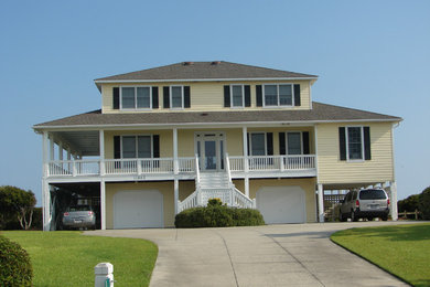 Inspiration for a large timeless yellow three-story wood exterior home remodel in Other