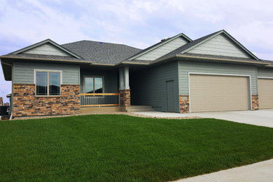 Traditional blue mixed siding exterior home idea in Other with a shingle roof