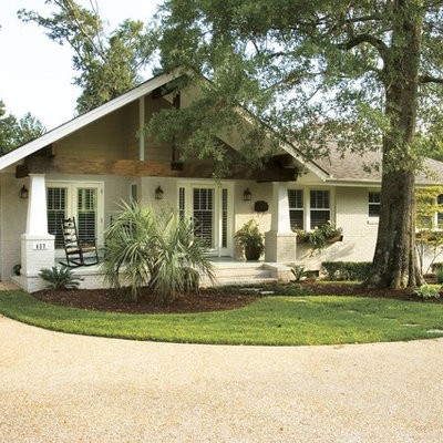 Example of an arts and crafts brick gable roof design in Other