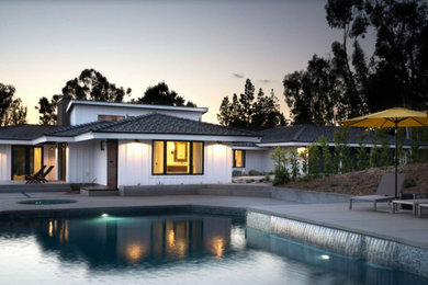 Large contemporary white one-story concrete fiberboard house exterior idea in San Diego with a hip roof and a shingle roof