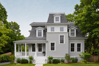 Large victorian gray three-story stucco house exterior idea in Chicago with a hip roof and a shingle roof