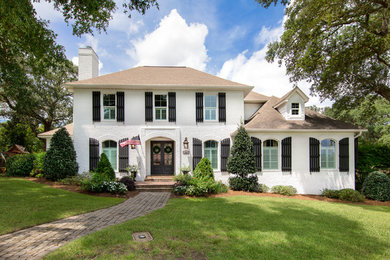 Example of a large classic two-story exterior home design in Other