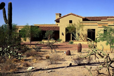 Expansive and brown mediterranean two floor clay house exterior in Phoenix.