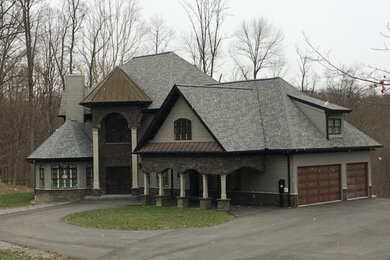Large elegant gray two-story wood house exterior photo in Other with a gambrel roof and a shingle roof