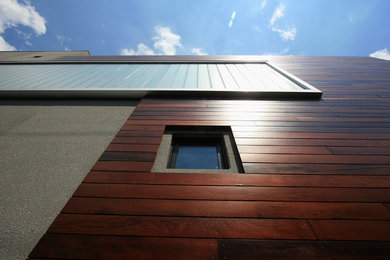 Inspiration for a mid-sized contemporary brown two-story mixed siding flat roof remodel in Chicago