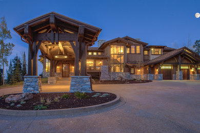 Example of a large mountain style brown two-story wood gable roof design in Salt Lake City