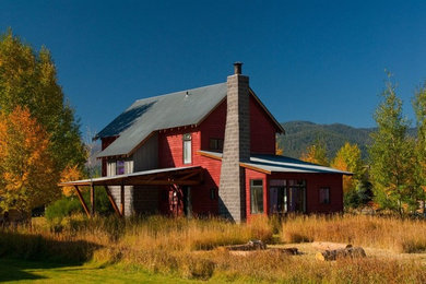 Example of a mid-sized mountain style red two-story wood exterior home design in Other
