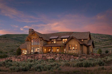 Example of a mountain style wood exterior home design in Phoenix with a mixed material roof