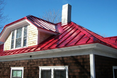 Elegant house exterior photo in Portland Maine with a metal roof and a red roof