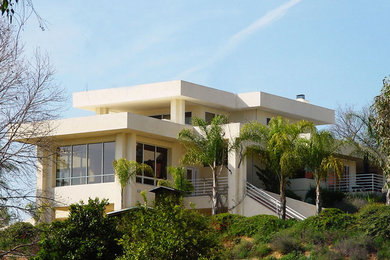 Inspiration for a large modern white three-story stucco flat roof remodel in San Diego
