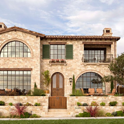 Inspiration for a mediterranean two-story stone exterior home remodel in Los Angeles