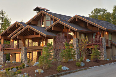 Example of a large mountain style multicolored three-story mixed siding exterior home design in Other with a shingle roof