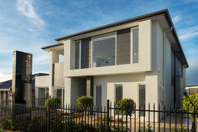 Modelo de fachada de casa minimalista grande de dos plantas con revestimiento de aglomerado de cemento