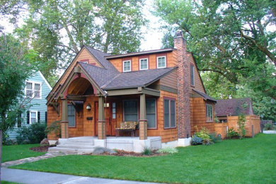 Large craftsman brown two-story wood exterior home idea in Boise with a shingle roof