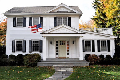 Inspiration for a timeless white three-story wood exterior home remodel in New York