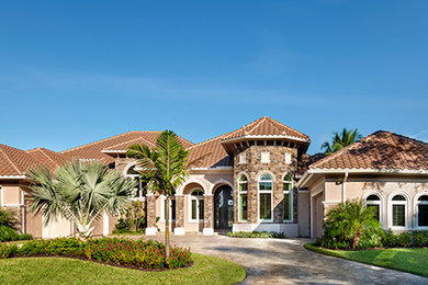 Traditional beige two-story exterior home idea in Miami