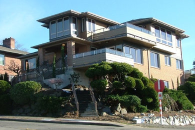 Example of a large classic beige two-story mixed siding gable roof design in Seattle