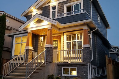 Mid-sized elegant blue two-story mixed siding house exterior photo in Vancouver with a shingle roof