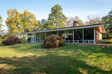 Example of a mid-century modern exterior home design in Other