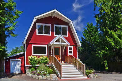 Inspiration for a large farmhouse house exterior in Seattle with three floors and wood cladding.