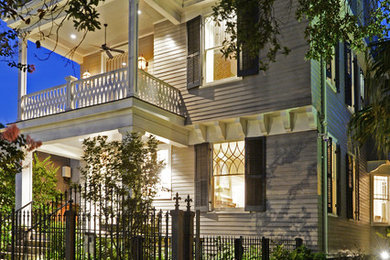 Inspiration for a large timeless gray two-story wood gable roof remodel in New Orleans