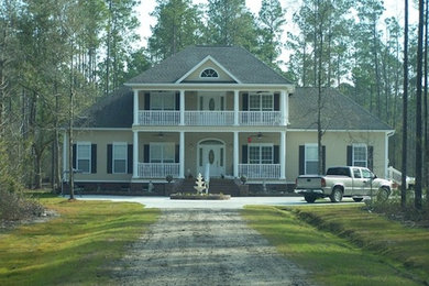 Example of a large yellow three-story exterior home design in Charleston