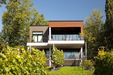 Trendy white three-story exterior home photo in Montreal