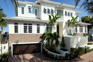 Example of a beach style three-story house exterior design in Miami