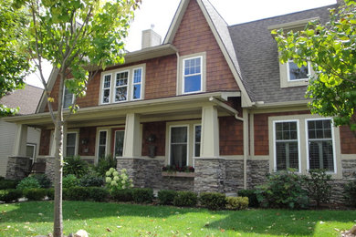 Example of a mid-sized classic two-story stone gable roof design in Detroit