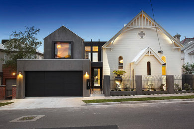 This is an example of a white contemporary two floor detached house in Melbourne with mixed cladding, a pitched roof and a metal roof.