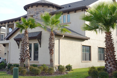 This is an example of a large and beige rustic two floor detached house in Tampa with a pitched roof, a shingle roof and mixed cladding.