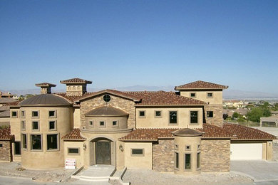 Large mediterranean beige two-story mixed siding house exterior idea in San Francisco with a hip roof and a mixed material roof