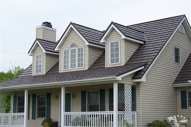 Example of a mid-sized classic beige two-story wood exterior home design in Raleigh