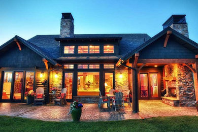 Mid-sized rustic brown two-story stone exterior home idea in Other