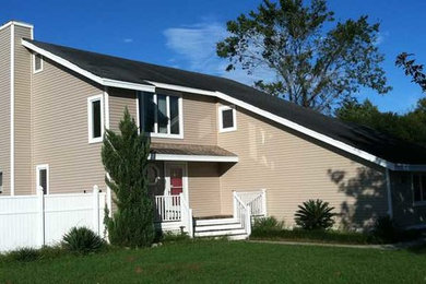 Inspiration for a transitional beige two-story exterior home remodel in Charleston