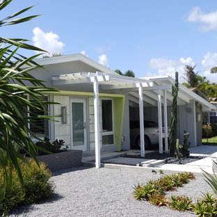 Design ideas for a midcentury one-storey grey exterior in Miami with a gable roof.