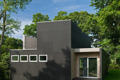 This is an example of a medium sized and black two floor house exterior in Richmond with mixed cladding.