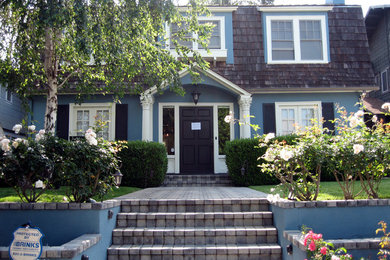 Inspiration for a large timeless blue two-story stucco exterior home remodel in Los Angeles