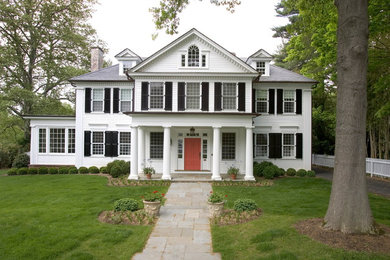 Large traditional white three-story wood exterior home idea in Other