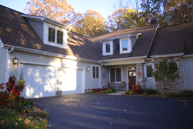 Example of a mid-sized gray two-story house exterior design in Other with a shingle roof