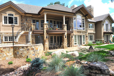 Large elegant beige one-story stone exterior home photo in Denver with a hip roof