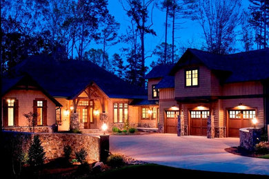 Large mountain style brown two-story wood house exterior photo in Atlanta with a hip roof and a shingle roof
