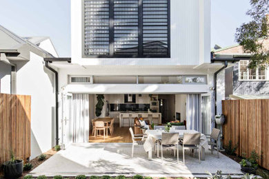 Inspiration for a medium sized and white contemporary two floor detached house in Sydney with wood cladding, a pitched roof and a metal roof.